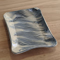Marbled ceramic dish on a white background