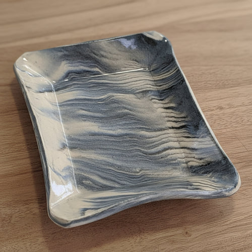 Marbled ceramic dish on a white background